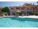 Community pool with chairs and townhouses in the background at 10224 N 12Th Pl # 1, Phoenix, AZ 85020