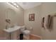 Inviting powder room featuring a pedestal sink, framed art, and neutral tones at 10224 N 12Th Pl # 1, Phoenix, AZ 85020