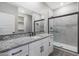 Bathroom featuring granite countertop, modern fixtures, and frameless glass shower enclosure at 10281 N 115Th Ave, Youngtown, AZ 85363