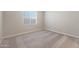 Bedroom featuring neutral carpeting, base trim, freshly painted walls, and window with blinds at 10281 N 115Th Ave, Youngtown, AZ 85363