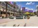 Vibrant outdoor shopping center boasting palm trees, dining options, and entertainment venues for residents at 10281 N 115Th Ave, Youngtown, AZ 85363