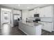 Stylish kitchen with a large island, stainless steel appliances, and ample cabinet space for storage at 10281 N 115Th Ave, Youngtown, AZ 85363