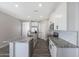 Modern kitchen featuring white cabinetry, stainless steel appliances, granite countertops, and a kitchen island at 10281 N 115Th Ave, Youngtown, AZ 85363