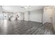 Open-concept living room with hardwood floors that seamlessly connects to the adjacent kitchen and dining area at 10281 N 115Th Ave, Youngtown, AZ 85363
