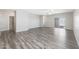 Spacious living room featuring hardwood floors and a sliding glass door leading to an outdoor space at 10281 N 115Th Ave, Youngtown, AZ 85363