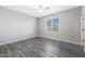 Serene bedroom featuring hardwood floors, a window providing natural light, and neutral walls at 10353 N 115Th Ave, Youngtown, AZ 85363
