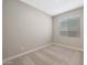 Cozy bedroom with neutral carpet, white trim, and a window for natural light at 10353 N 115Th Ave, Youngtown, AZ 85363