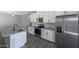Modern kitchen with stainless steel appliances, white cabinets, and a large island at 10353 N 115Th Ave, Youngtown, AZ 85363