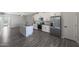 Modern kitchen view, showcasing white cabinets, stainless steel appliances, and a kitchen island at 10353 N 115Th Ave, Youngtown, AZ 85363