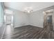 Spacious living room with gray wood floors, a ceiling fan, and lots of natural light at 10353 N 115Th Ave, Youngtown, AZ 85363