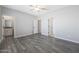 Spacious main bedroom features wood-look flooring, a ceiling fan, and neutral paint at 10353 N 115Th Ave, Youngtown, AZ 85363