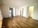 Large primary bedroom with wood-look flooring, ensuite bathroom, walk-in closet, and ample natural light at 10828 N Biltmore Dr # 133, Phoenix, AZ 85029