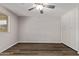 Bedroom featuring a ceiling fan, window, wood floors, and a closet at 12211 N 25Th Ave, Phoenix, AZ 85029
