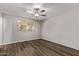 Cozy bedroom with wood floors, ceiling fan, and a bright window at 12211 N 25Th Ave, Phoenix, AZ 85029