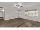 Bright living room featuring wood floors, a modern ceiling fan, and natural light at 12211 N 25Th Ave, Phoenix, AZ 85029