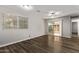 Bright living room with wood floors, ceiling fan, sliding glass doors to the patio, and neutral paint at 12211 N 25Th Ave, Phoenix, AZ 85029