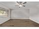 Bright living room featuring wood floors, a modern ceiling fan, and natural light at 12211 N 25Th Ave, Phoenix, AZ 85029