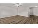 Bright living room featuring wood floors, a modern ceiling fan, and neutral paint at 12211 N 25Th Ave, Phoenix, AZ 85029