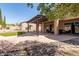 Backyard featuring a covered patio, low-maintenance desert landscaping, and synthetic grass at 12442 N Via La Playa --, Fountain Hills, AZ 85268
