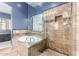 Luxurious bathroom featuring a tub and glass-enclosed tiled shower, creating a spa-like experience at 12442 N Via La Playa --, Fountain Hills, AZ 85268
