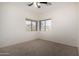 Bright bedroom with carpeted floors, neutral-colored walls, and neighborhood views through two windows at 12442 N Via La Playa --, Fountain Hills, AZ 85268
