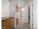 Hallway with carpeted floors, multiple doors, a granite countertop, and wooden cabinets at 12442 N Via La Playa --, Fountain Hills, AZ 85268