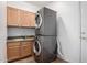 Functional laundry room with stacked washer and dryer, granite countertop, and matching wood cabinets at 12442 N Via La Playa --, Fountain Hills, AZ 85268