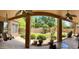 Covered back patio with ceiling fans, perfect for outdoor relaxation and entertaining with lush green landscaping at 1339 N Tucana Ln, Gilbert, AZ 85234
