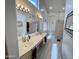 Bathroom with double sink vanity, large mirrors, ample lighting, and tile flooring at 1339 N Tucana Ln, Gilbert, AZ 85234