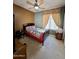 Cozy bedroom with a ceiling fan, soft lighting, and patterned quilt that provides a relaxed and inviting atmosphere at 1339 N Tucana Ln, Gilbert, AZ 85234