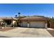 Traditional home featuring a three-car garage, tile roof, and desert landscaping for easy maintenance at 1339 N Tucana Ln, Gilbert, AZ 85234