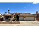 Charming home featuring a tile roof, three-car garage, and a desert landscaped front yard with palm trees at 1339 N Tucana Ln, Gilbert, AZ 85234