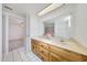 Bathroom featuring a large mirror above a double sink vanity with cabinets at 13633 N 40Th Dr, Phoenix, AZ 85029