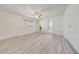 Well-lit bedroom with light wood-look flooring, ceiling fan, and access to an ensuite bathroom at 13633 N 40Th Dr, Phoenix, AZ 85029