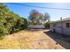 Spacious backyard featuring natural landscaping, a fenced perimeter, and a neutral-toned home at 1404 E Hall St, Tempe, AZ 85281