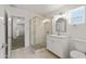 Modern bathroom featuring a glass-enclosed shower, vanity with sink, and marble flooring at 1404 E Hall St, Tempe, AZ 85281