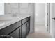 Bathroom featuring a double sink vanity, black cabinets and neutral countertops at 14194 W Sand Hills Rd, Surprise, AZ 85387