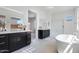 Bright bathroom featuring dual vanities, a soaking tub, and a separate shower in a modern setting at 14194 W Sand Hills Rd, Surprise, AZ 85387