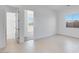 Tiled bedroom featuring an open doorway and window at 14194 W Sand Hills Rd, Surprise, AZ 85387