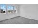 Bright bedroom featuring plush carpeting and large windows offering neighborhood views at 14194 W Sand Hills Rd, Surprise, AZ 85387