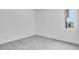 Empty bedroom with carpet flooring and a large window at 14194 W Sand Hills Rd, Surprise, AZ 85387