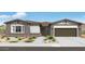 Charming single-story home with stone accents, a two car garage, and professionally landscaped yard at 14194 W Sand Hills Rd, Surprise, AZ 85387