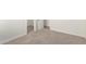 Open bedroom with carpet flooring, white trim, and doorway to another room at 1588 S 226Th Dr, Buckeye, AZ 85326