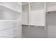 Organized walk-in closet featuring white shelving, drawers, and chrome hardware at 1588 S 226Th Dr, Buckeye, AZ 85326