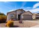 Charming single-story home featuring desert landscaping and an attached two-car garage at 1588 S 226Th Dr, Buckeye, AZ 85326