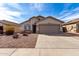 Single story home with low maintenance desert landscaping and a two car garage at 1588 S 226Th Dr, Buckeye, AZ 85326