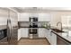 Modern kitchen featuring white cabinets, stainless steel appliances, and dark countertops at 1588 S 226Th Dr, Buckeye, AZ 85326