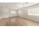 Bright, airy living room featuring wood-look flooring and ample natural light at 1588 S 226Th Dr, Buckeye, AZ 85326