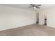 Comfortable main bedroom with carpet, a ceiling fan, and an ensuite bathroom at 1588 S 226Th Dr, Buckeye, AZ 85326