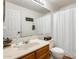 Clean and bright bathroom featuring a large mirror, a white shower curtain and a wood vanity at 1600 N Saba St # 177, Chandler, AZ 85225